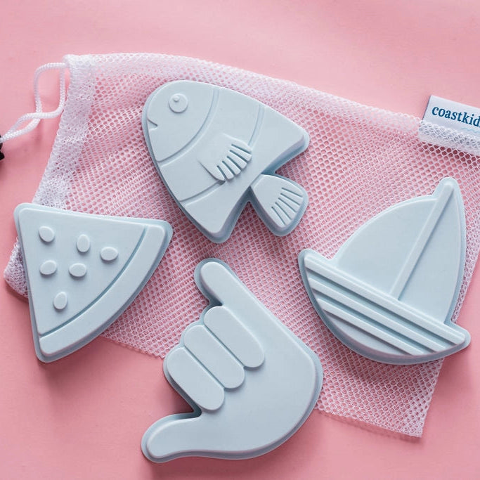 Set of blue bath toy shapes including a fish, pizza slice, hand, and sailboat on a pink background with &