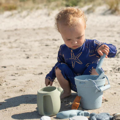 Child playing with sand toys on a beach