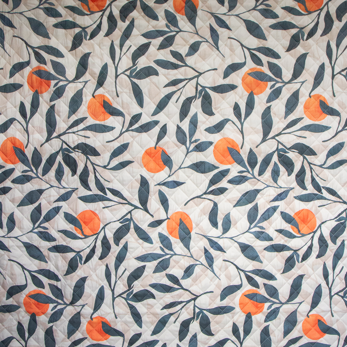 A rectangular orange grove design messy mat with a waterproof base, suitable for catching spills and messes.