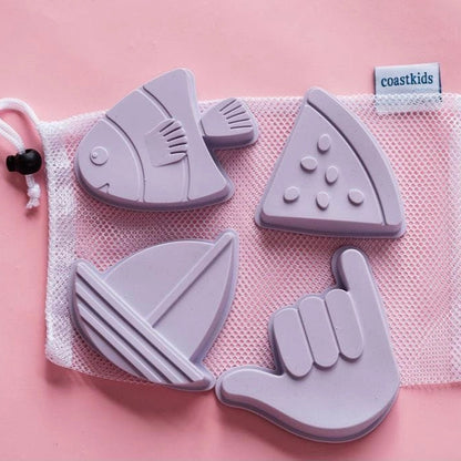 Set of purple silicone teethers with a mesh storage bag on a pink background