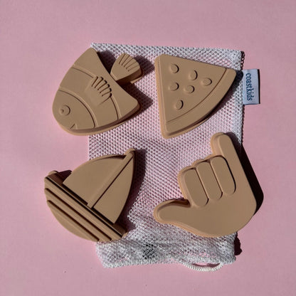 Set of brown silicone molds on a pink background