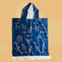 Blue hooded towel with white patterns on a beige background